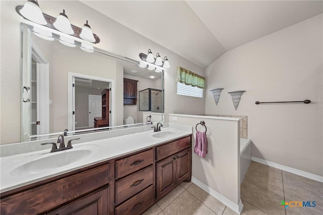 519 Gianotti Ct, Temple, TX 76502 - full bath with double vanity, vaulted ceiling, an enclosed shower, tile patterned flooring, and a bath