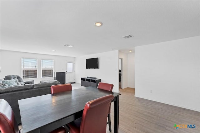 dining space with light wood-style flooring, recessed lighting, baseboards, and visible vents