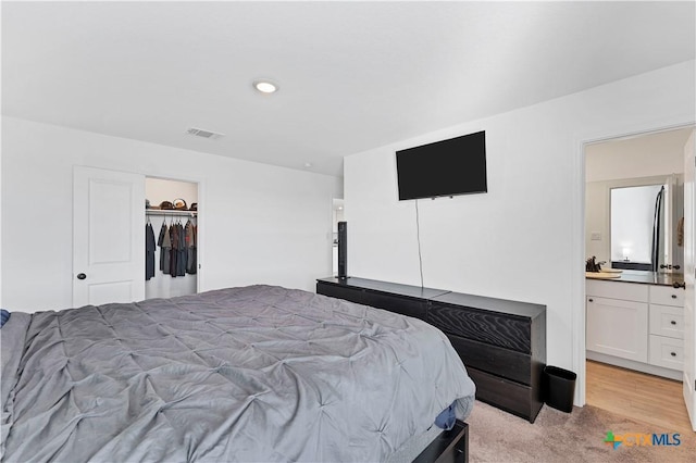 bedroom featuring visible vents and light carpet