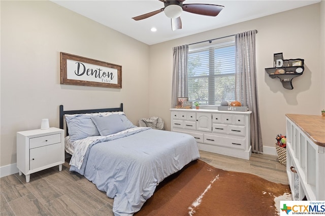 bedroom with light hardwood / wood-style flooring and ceiling fan