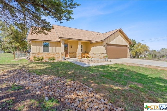 view of front of house with a garage and a front lawn