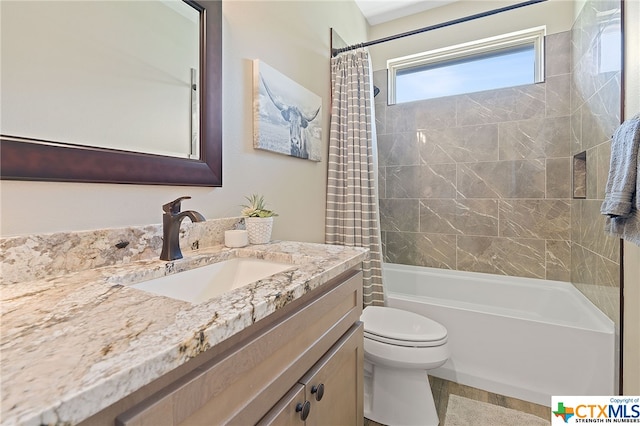 full bathroom featuring toilet, vanity, and shower / bath combination with curtain