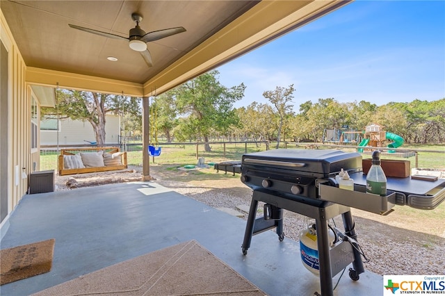 view of patio / terrace featuring a playground and ceiling fan