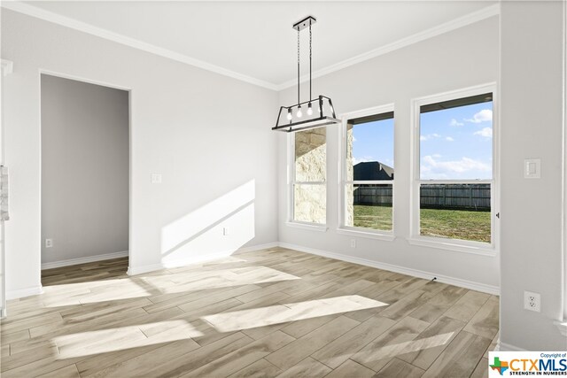 unfurnished dining area with ornamental molding and light hardwood / wood-style flooring