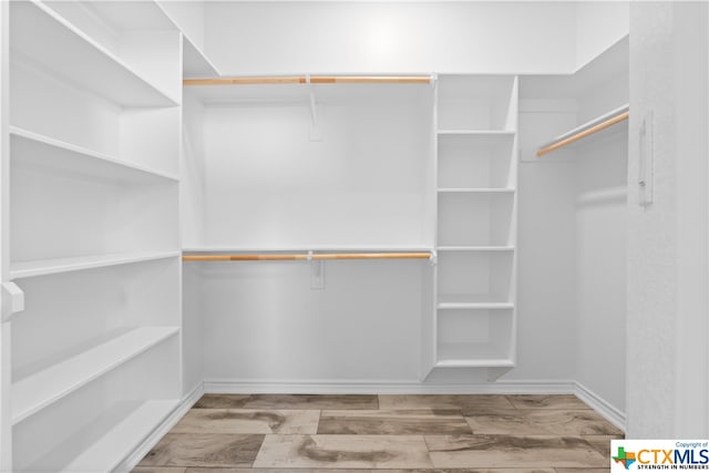 spacious closet with light wood-type flooring