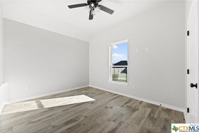 spare room featuring lofted ceiling, ceiling fan, and light hardwood / wood-style flooring