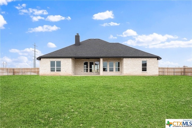 back of house featuring a yard