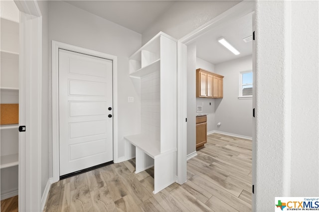 mudroom with light hardwood / wood-style floors