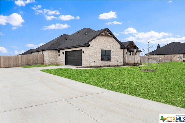 rear view of house featuring a garage and a yard