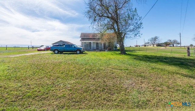 view of yard with a rural view