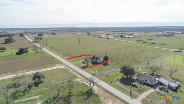 birds eye view of property with a rural view