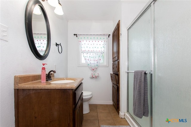 4417 S Pea Ridge Rd, Temple, TX 76502 - bathroom with vanity, a shower stall, tile patterned floors, toilet, and ornamental molding