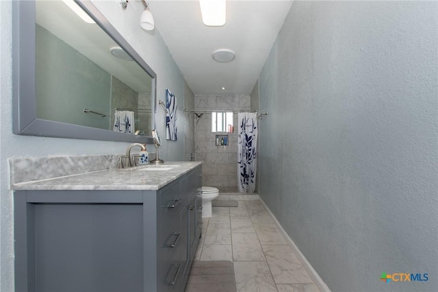 4417 S Pea Ridge Rd, Temple, TX 76502 - bathroom featuring marble finish flooring, vanity, toilet, a tile shower, and baseboards