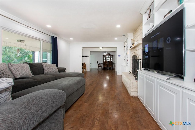 4417 S Pea Ridge Rd, Temple, TX 76502 - living area with ornamental molding, dark wood-type flooring, ceiling fan, recessed lighting, and a stone fireplace