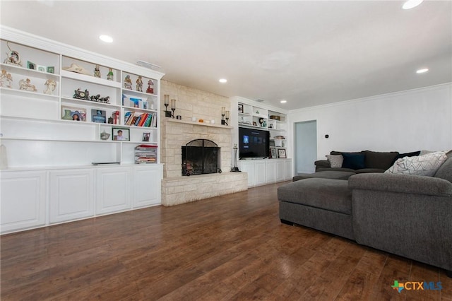 4417 S Pea Ridge Rd, Temple, TX 76502 - living room with dark wood-style floors, ornamental molding, a fireplace, recessed lighting, and built in features