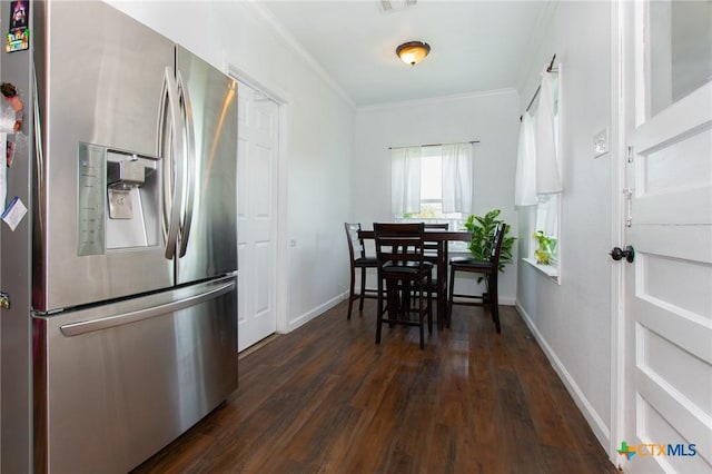 4417 S Pea Ridge Rd, Temple, TX 76502 - dining space with ornamental molding, dark wood finished floors, and baseboards