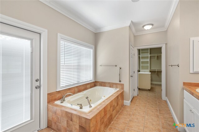 bathroom with ornamental molding, vanity, tiled tub, and tile patterned floors