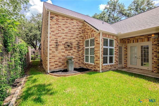 407 E Santa Rosa St, Victoria, TX 77901 - rear view of property with french doors, brick siding, and a shingled roof
