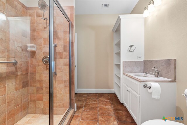 bathroom featuring vanity and an enclosed shower