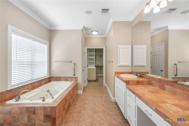 bathroom featuring vanity, tile patterned flooring, a relaxing tiled tub, and ornamental molding