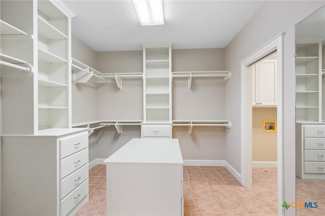 walk in closet featuring light tile patterned flooring