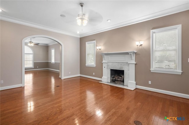407 E Santa Rosa St, Victoria, TX 77901 - unfurnished living room with a ceiling fan, wood finished floors, a fireplace, and ornamental molding