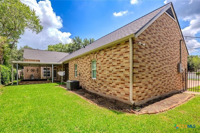 view of property exterior with a patio area and a lawn