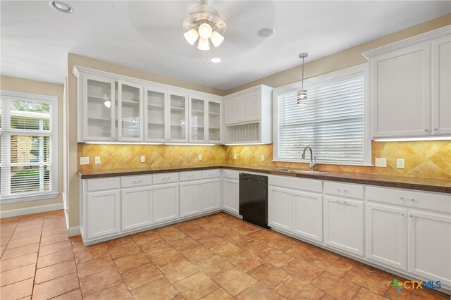 kitchen with white cabinets, sink, backsplash, and black dishwasher