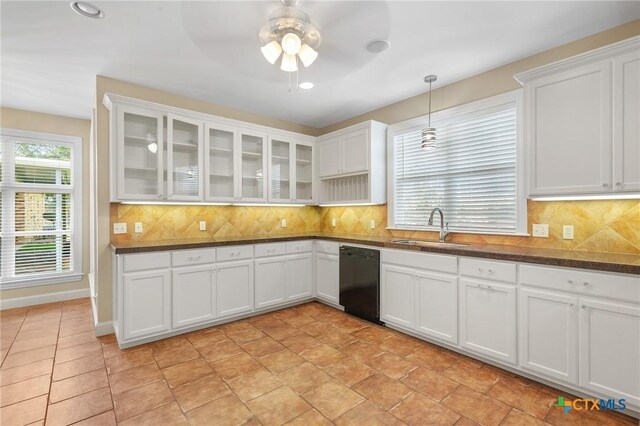 407 E Santa Rosa St, Victoria, TX 77901 - kitchen featuring black dishwasher, a sink, a ceiling fan, dark countertops, and white cabinets
