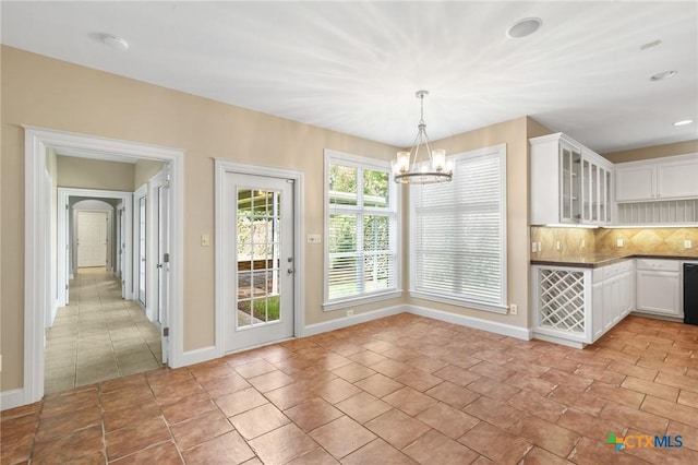 407 E Santa Rosa St, Victoria, TX 77901 - unfurnished dining area with a chandelier, baseboards, and recessed lighting
