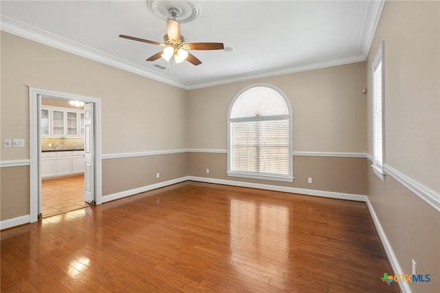 spare room with ornamental molding, light hardwood / wood-style floors, and ceiling fan