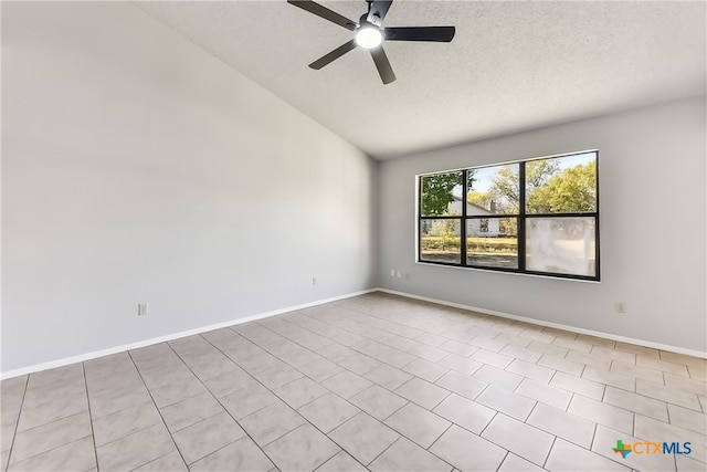 tiled spare room with a textured ceiling, ceiling fan, and lofted ceiling