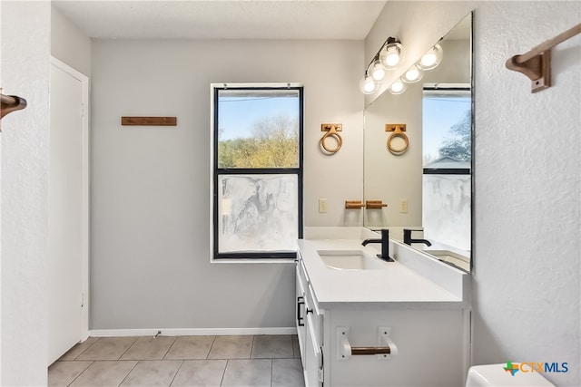 bathroom with tile patterned floors and vanity