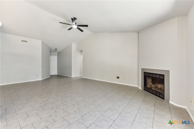 unfurnished living room featuring ceiling fan, lofted ceiling, and a tiled fireplace