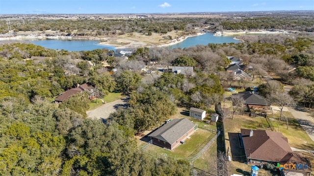 drone / aerial view with a water view and a wooded view