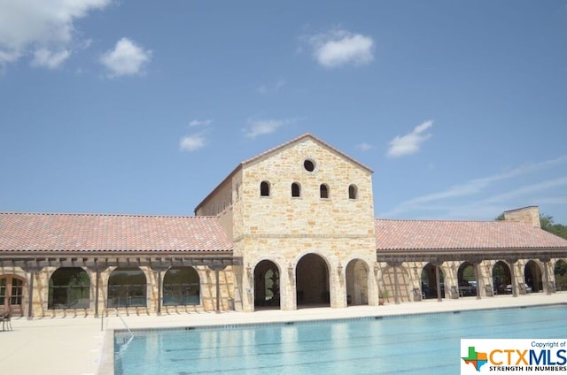 view of swimming pool featuring a patio area