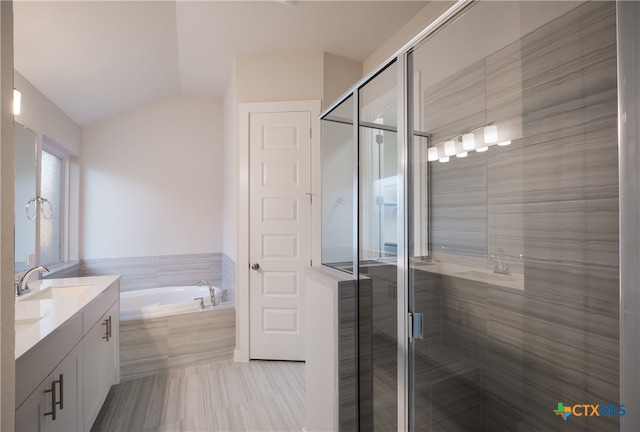 bathroom with lofted ceiling, vanity, and plus walk in shower