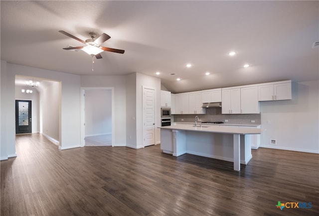 kitchen featuring stainless steel appliances, dark hardwood / wood-style floors, sink, white cabinets, and a kitchen island with sink