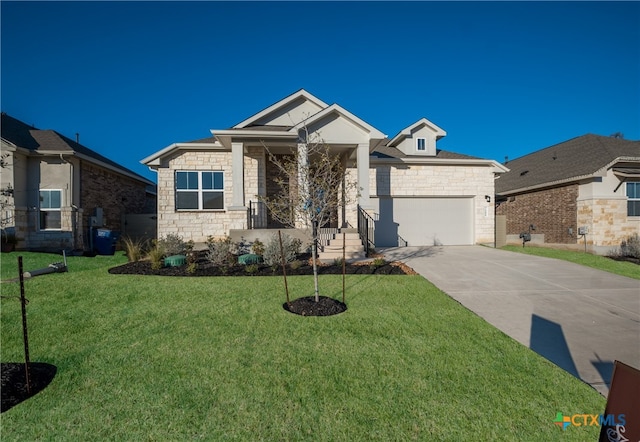 view of front of property with a front yard and a garage