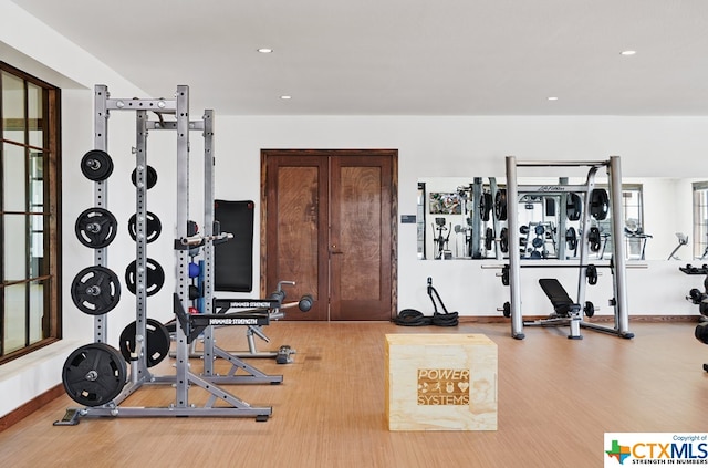 workout area with hardwood / wood-style flooring