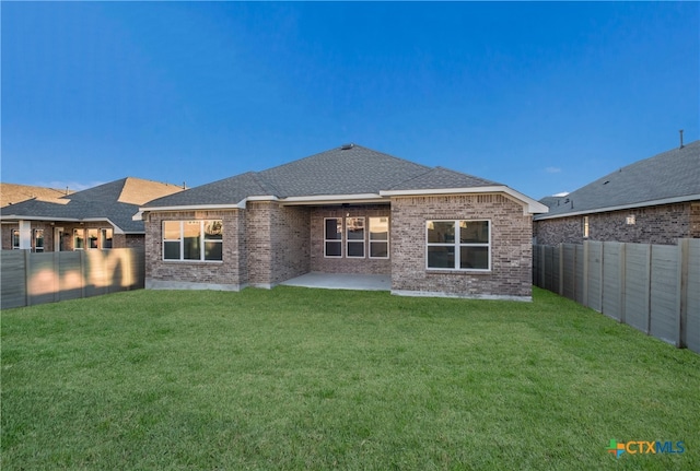 back of property featuring a patio area and a lawn