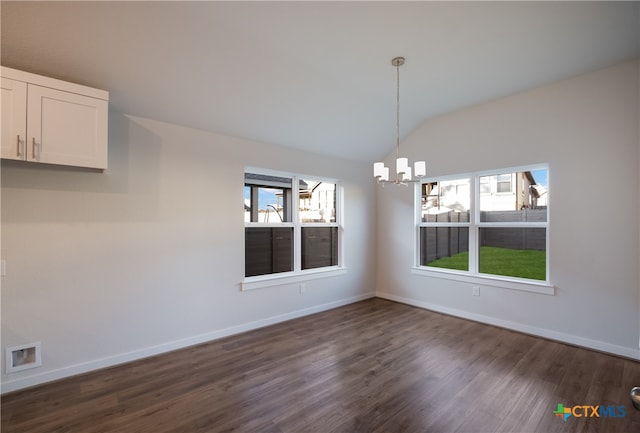 unfurnished dining area with dark wood-type flooring, lofted ceiling, and a notable chandelier