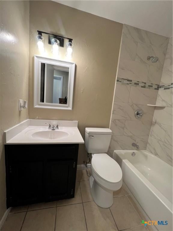 bathroom with baseboards, toilet, vanity, tile patterned floors, and shower / bathtub combination