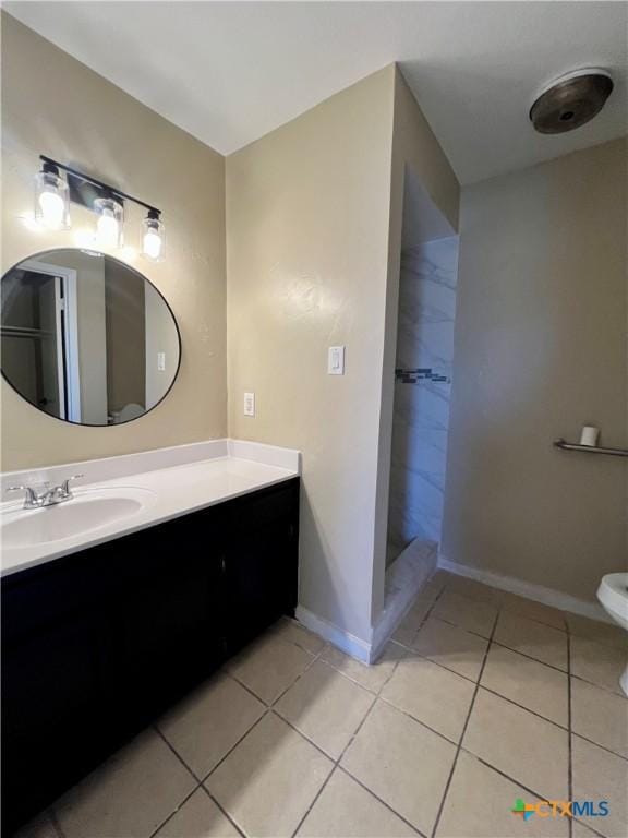 full bath featuring a walk in shower, tile patterned flooring, vanity, and baseboards