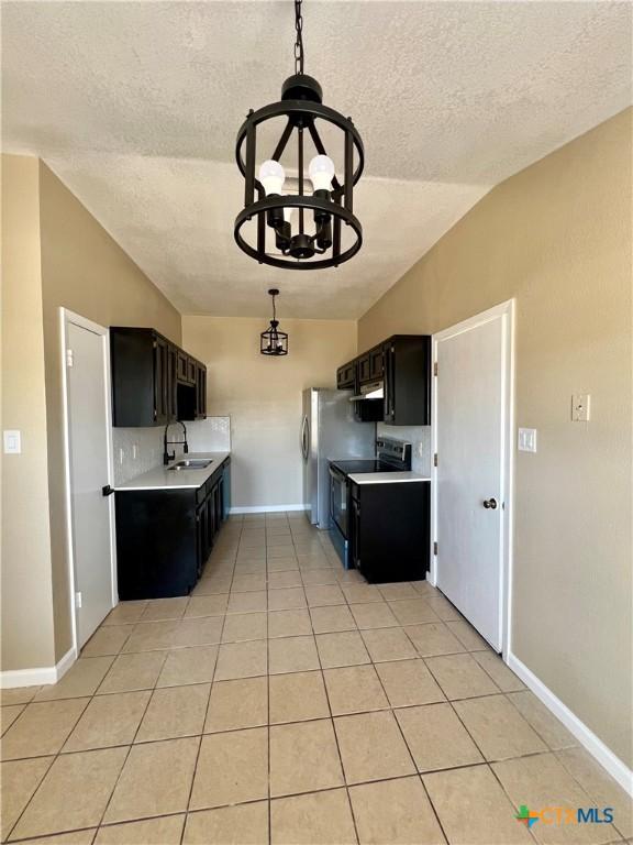 kitchen with light countertops, dark cabinetry, black range with electric stovetop, and light tile patterned floors