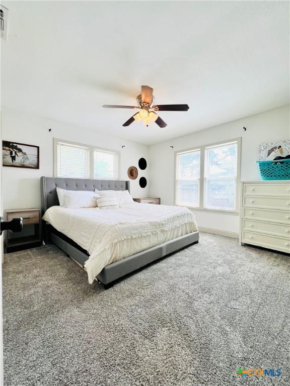 613 E 5th St, Cameron, TX 76520 - bedroom with carpet floors and a ceiling fan
