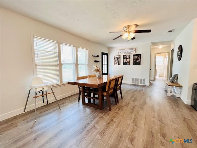 613 E 5th St, Cameron, TX 76520 - dining area featuring light wood finished floors, baseboards, and ceiling fan