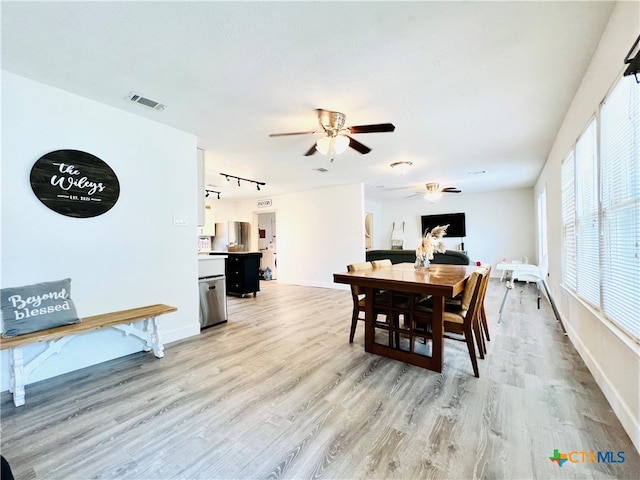 dining room with ceiling fan and light hardwood / wood-style flooring