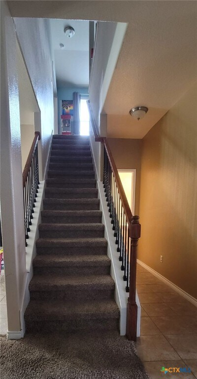 1910 Deerfield Way, Harker Heights, TX 76548 - staircase featuring tile patterned flooring and baseboards