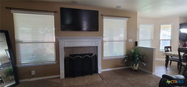 1910 Deerfield Way, Harker Heights, TX 76548 - living room featuring a tile fireplace, light carpet, and baseboards